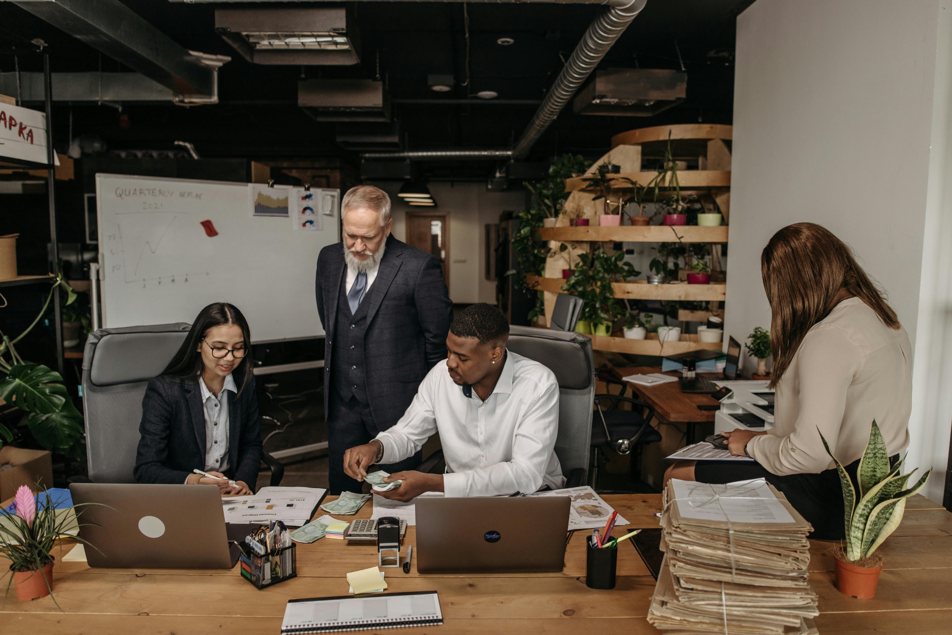 Small business team reviewing payroll and hiring documents together
